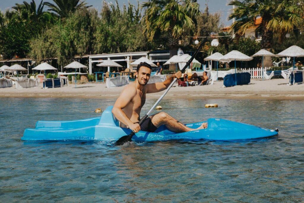 Man paddleboarding at a marina